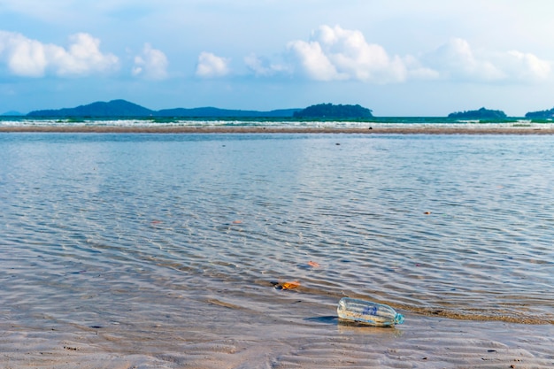 Waste water bottles that float on the beach side, environmental pollution problems from human beings.