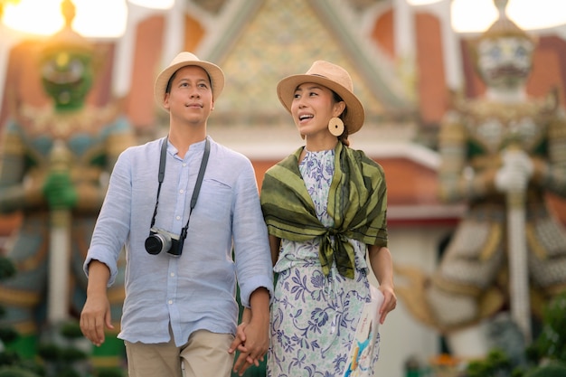 Wat Arun Ratchawararam temple. Couple traveller walking in the temple