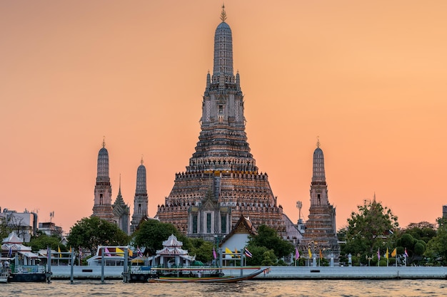 Wat Arun Stupa a landmark of Bangkok Thailand stands prominently along the Chao Phraya River