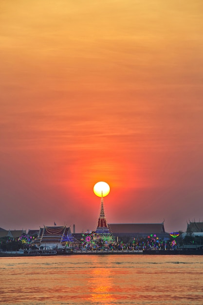 Wat Phra Samut Chedi with lighting on the river Chao Phraya. at sunset In Thailand.