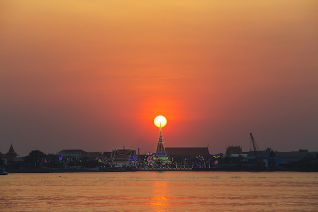 Wat Phra Samut Chedi with lighting on the river Chao Phraya. at sunset In Thailand.