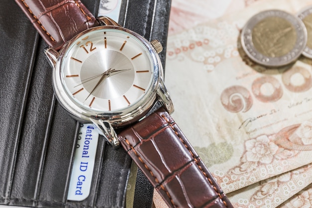 Watch and wallet on banknote