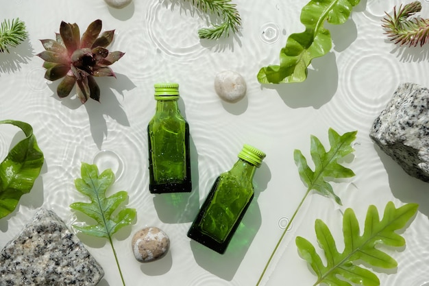 Water background cosmetic skincare moisturizer in green bottles Dark glass bottles Water surface