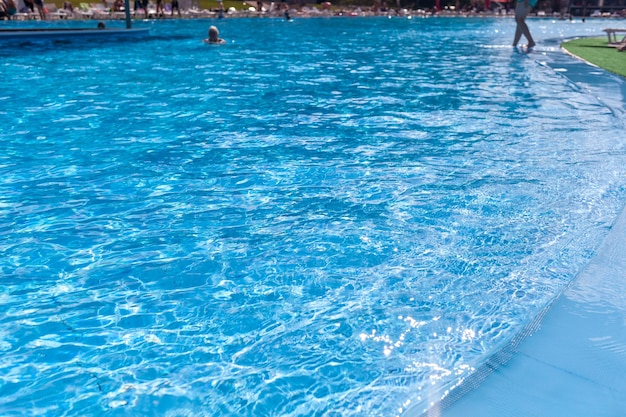 Water background, ripple and flow with waves. Summer blue swimming pool pattern. Sea, ocean surface.