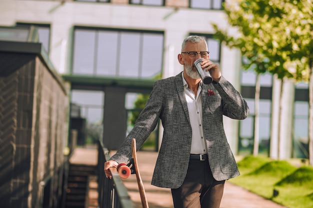 Water balance. A man in an elegant jacket with a bottle in hand