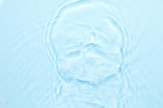 Water blue surface abstract background Waves and ripples of cosmetic moisturizer with bubbles