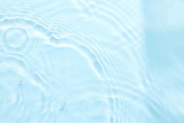 Water blue surface abstract background Waves and ripples of cosmetic moisturizer with bubbles