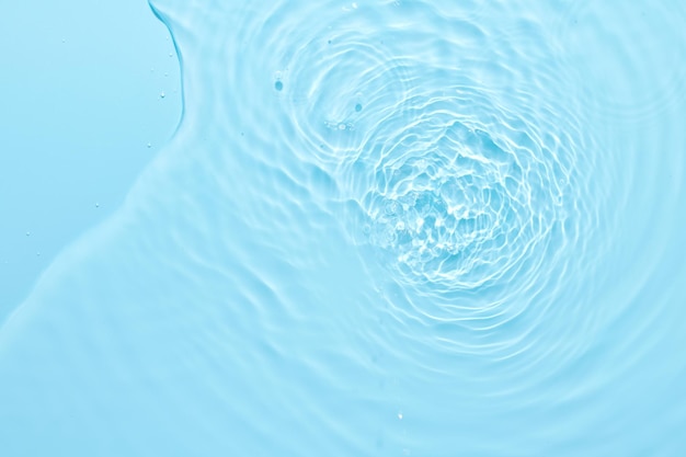 Water blue surface abstract background Waves and ripples of cosmetic moisturizer with bubbles