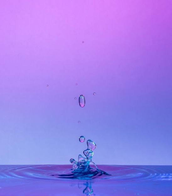 Water Drop Collisions Macro Photography with pink and blue background