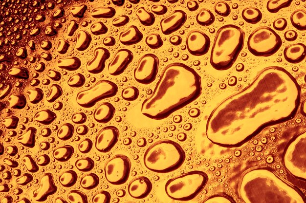 Water droplets on golden metal a beautiful unusual texture