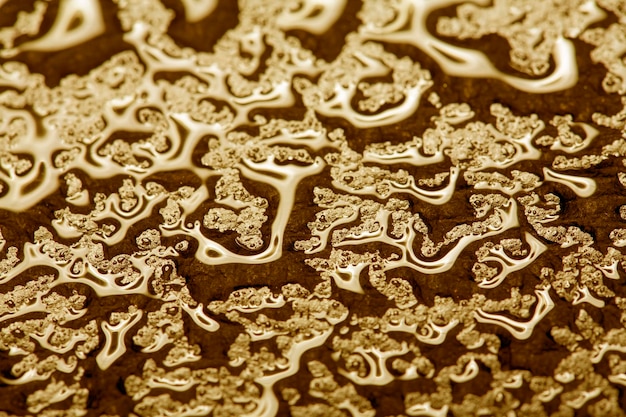 Water droplets on golden metal a beautiful unusual texture