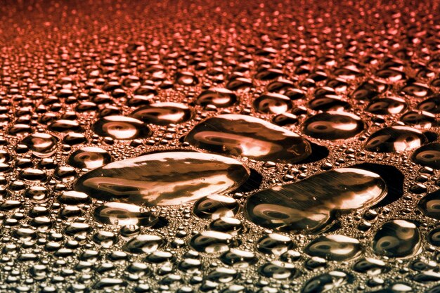 Water droplets on golden metal a beautiful unusual texture