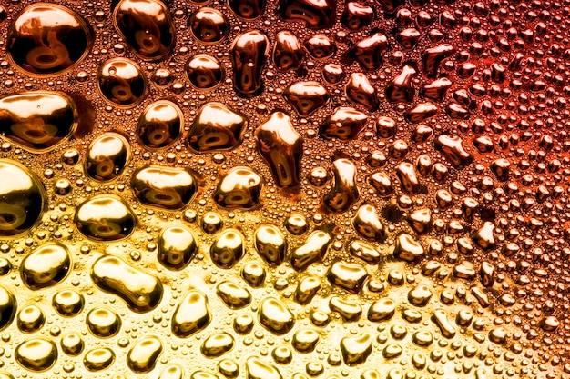 Water droplets on golden metal a beautiful unusual texture