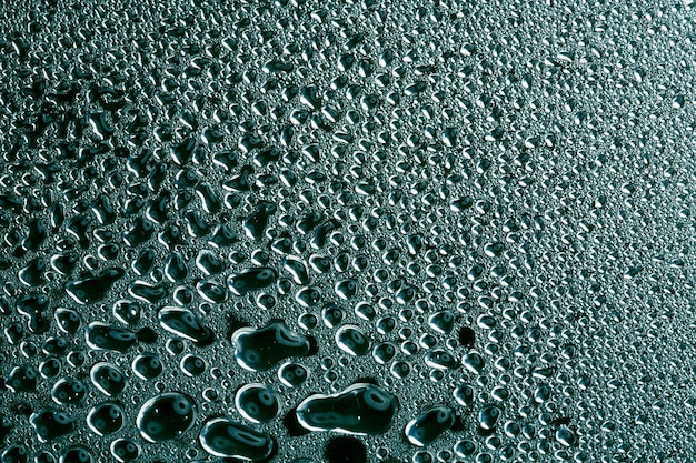 Water droplets on green metal a beautiful unusual texture