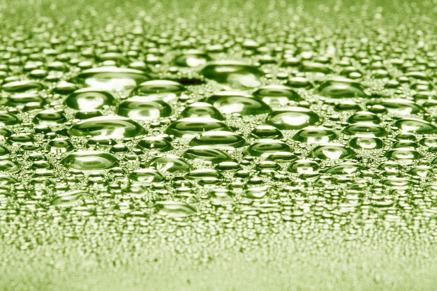 Water droplets on green metal a beautiful unusual texture