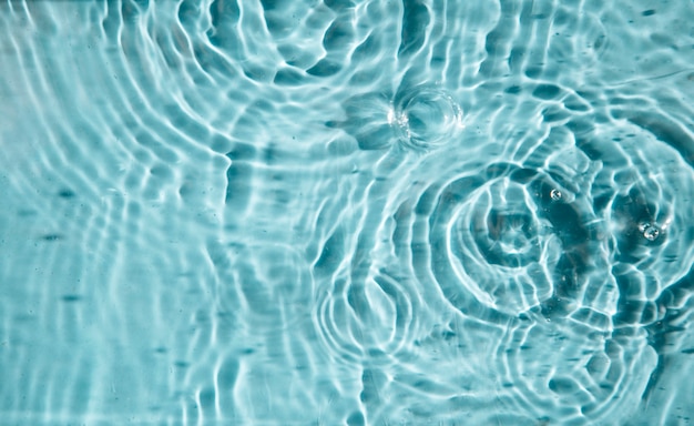 Water drops on a blue background a background for demonstrating cosmetics