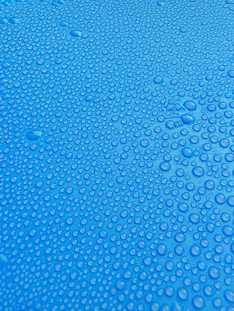 Water drops on blue background texture backdrop glass covered with drops of water Bubbles in water