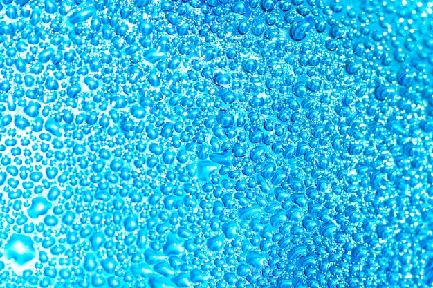 Water drops on blue glass