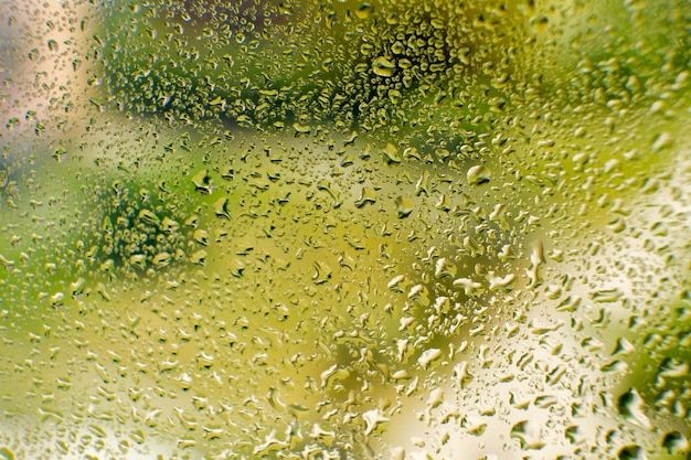 Water drops on glass water flows down the glass