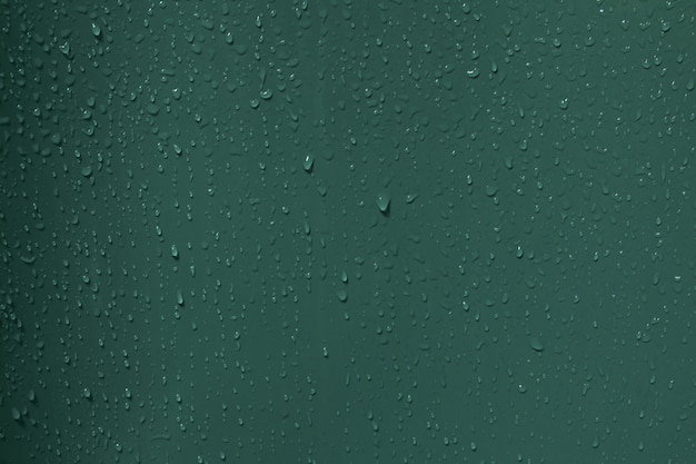 Water drops on green plastic background