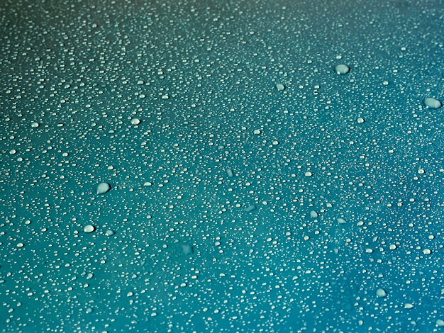 Water drops on turquoise surface