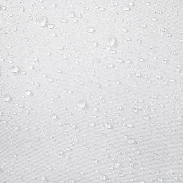 Water drops on waterproof fabric background. Raindrops on white umbrella.