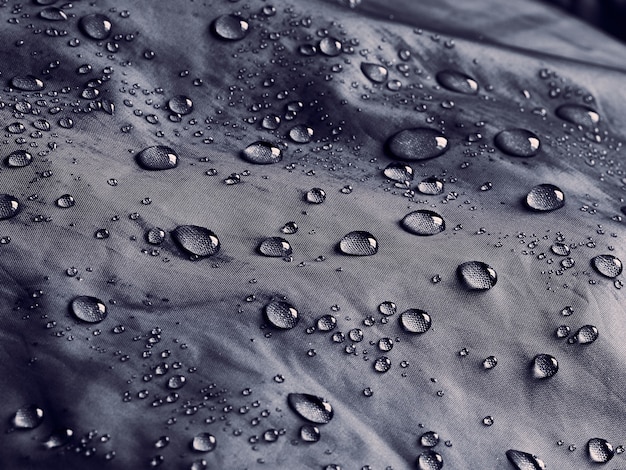 Water drops on waterproof membrane fabric. Detail view of waterproof cloth.