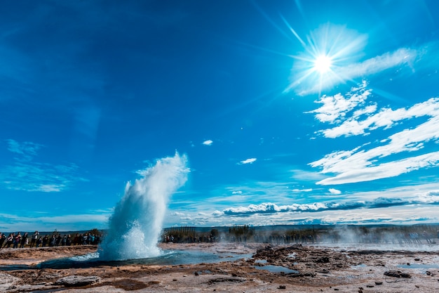 Water explosion in the Geysir Strokkur with the sun in the background of the golden circle of the south of Iceland