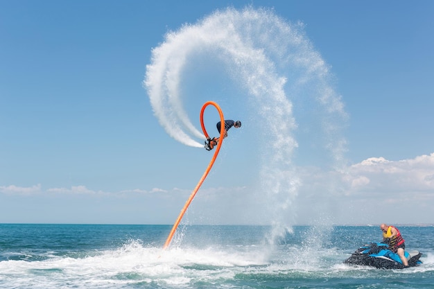 Water extreme sport A man flies on a water flyboard