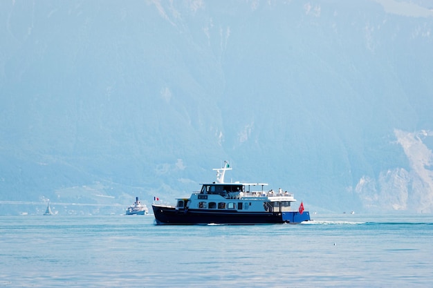 Water ferry on Lake Geneva at Ouchy embankment at Lausanne, Switzerland. People aboard