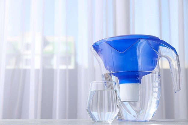 A water filter with a glass on a light background