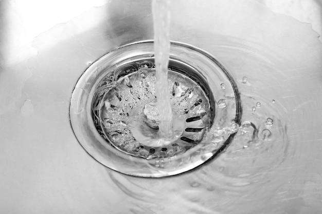 Water flowing down hole in kitchen sink