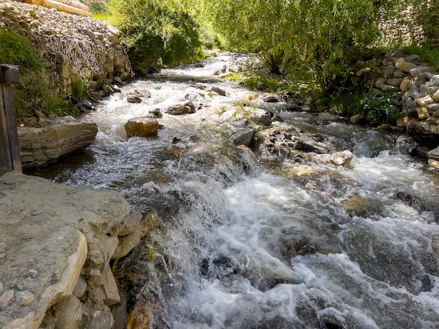 The water flows in the creek fast and rushingly