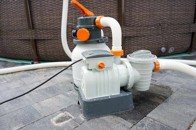 A water hose with orange knobs on it