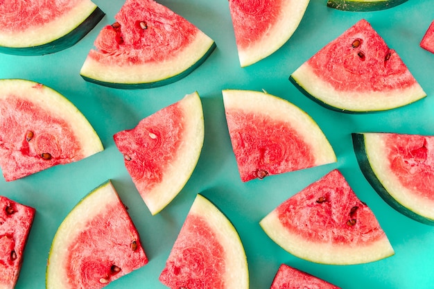 Water melon slices on blue background. Juicy fresh tasty summer dessert. Top view stock photo