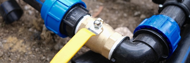 Water pipe connector with faucet closeup for watering plants in garden country sewerage