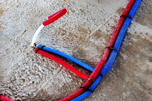 Water pipes corrugated in red and blue Plumbing system in the floor Pipe laying on the floor of the house