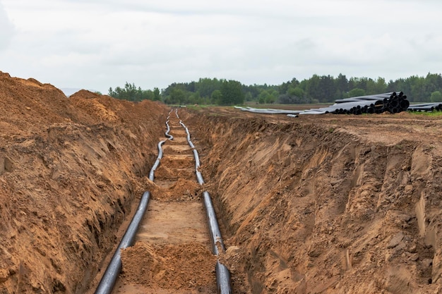 Water pipes for drinking water supply lie on the construction site Preparation for earthworks for laying an underground pipeline Modern water supply systems for a residential city