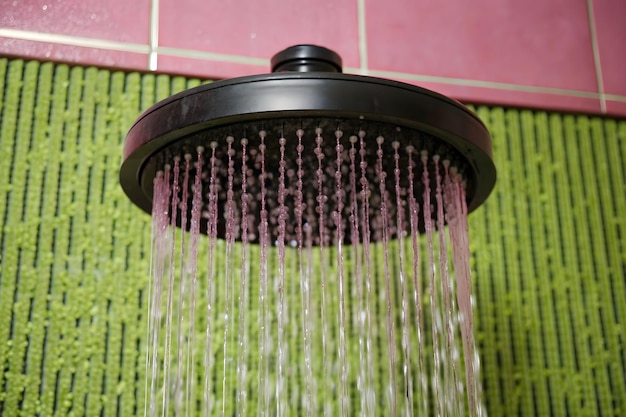 Water running from a black rain shower head