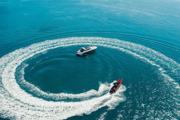 Water scooter movement close to the yacht aerial view