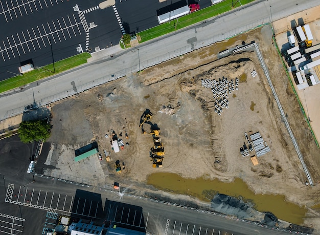 Water and sewage pipes stacked in ground during plumbing construction site