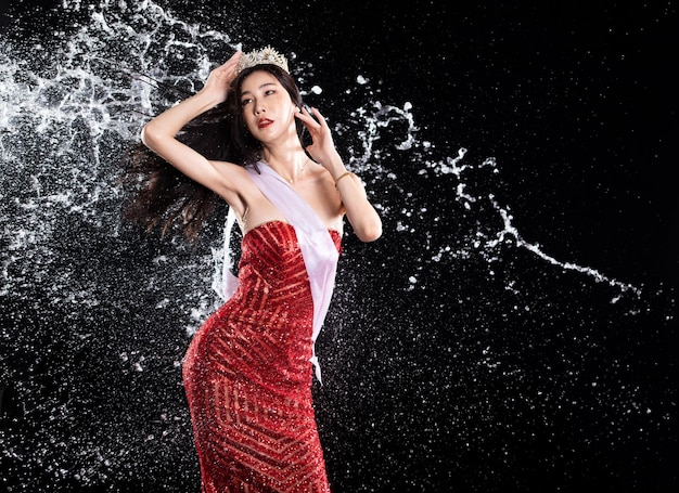 Water splash to back side of Miss Beauty Pageant Contest with diamond crown sash in droplet