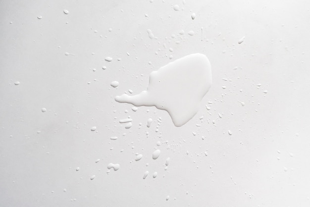 A water splash lit on the white table surface, abstract raindrops