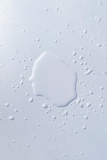 A water splash lit on the white table surface, abstract raindrops