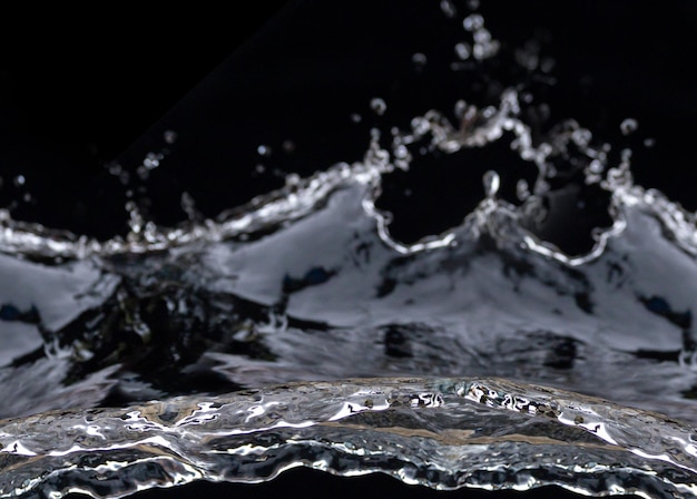 Water splashes in the air. Water waves and airdrops, natural air water movement and black background