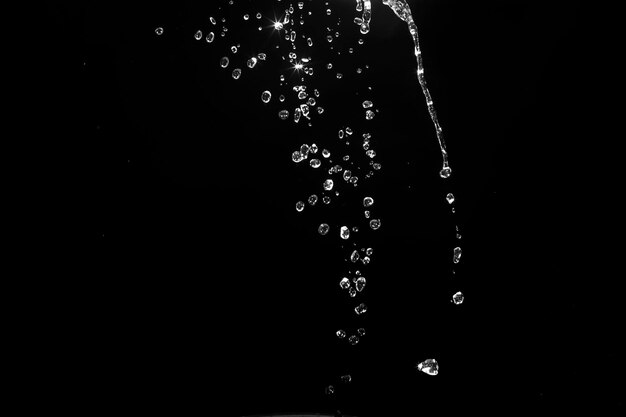 Water splashes isolated on black background white jets with drops