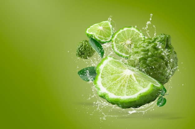 Water splashing on Bergamot fruit on green background