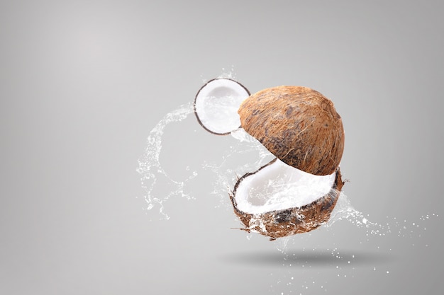 Water splashing on coconuts on a white background