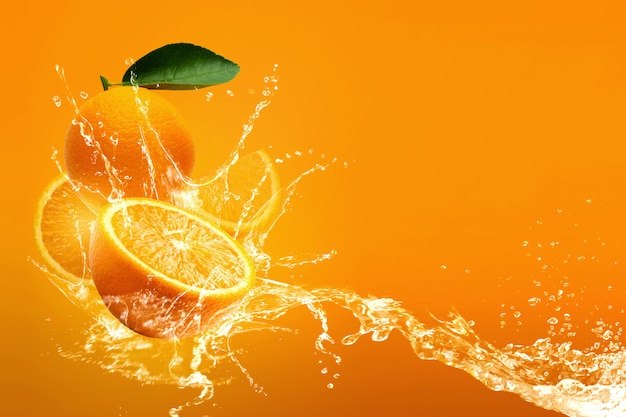 Water splashing on Fresh Sliced oranges and Orange fruit over Orange background