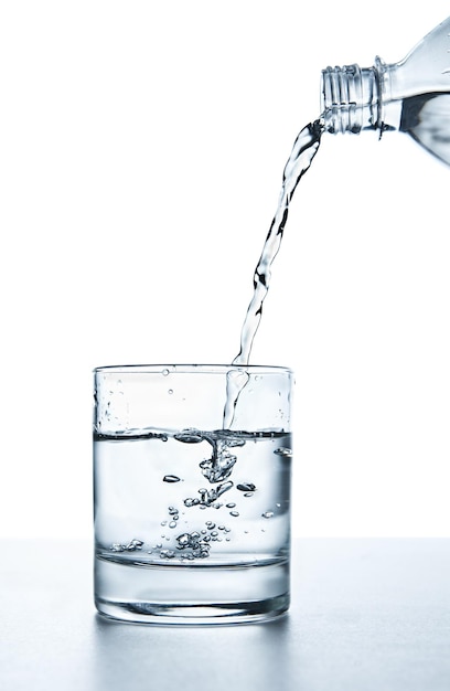 Water splashing from glass isolated on white background